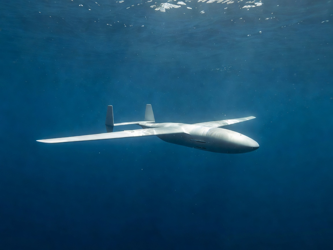 Autonomous underwater drone glider floating through open blue ocean water